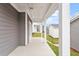 A covered back porch with classic white columns creates an inviting outdoor living area at 9301 Kitchin Farms Way # 433, Wake Forest, NC 27587
