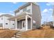 Home's backyard features neutral siding, white trim, and a covered porch with steps to the yard at 9301 Kitchin Farms Way # 433, Wake Forest, NC 27587