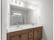 Bright bathroom features double sinks with a large mirror and modern lighting at 9301 Kitchin Farms Way # 433, Wake Forest, NC 27587