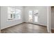 Well-lit bedroom featuring hardwood floors and a door to the outside at 9301 Kitchin Farms Way # 433, Wake Forest, NC 27587