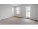 Bright bedroom with a window, a door to the outside, and neutral carpet at 9301 Kitchin Farms Way # 433, Wake Forest, NC 27587