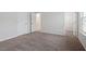 This bedroom features a neutral color palette, plush carpeting, and two doors at 9301 Kitchin Farms Way # 433, Wake Forest, NC 27587