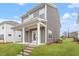 Home exterior featuring a covered porch with white columns and well-maintained landscaping at 9301 Kitchin Farms Way # 433, Wake Forest, NC 27587