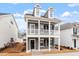 Beautiful two-story home featuring a covered porch with white columns and black shutters at 9301 Kitchin Farms Way # 433, Wake Forest, NC 27587