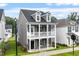 Two-story home boasts a charming front porch, providing an inviting curb appeal at 9301 Kitchin Farms Way # 433, Wake Forest, NC 27587
