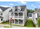 Charming two-story home with a welcoming front porch, dormer windows and manicured lawn at 9301 Kitchin Farms Way # 433, Wake Forest, NC 27587