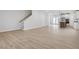 Open-concept living room showcasing hardwood floors with a view of the kitchen and stairs at 9301 Kitchin Farms Way # 433, Wake Forest, NC 27587