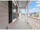 View of the outdoor porch with white railing showcasing the surrounding neighborhood at 9301 Kitchin Farms Way # 433, Wake Forest, NC 27587