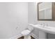 Bathroom featuring a pedestal sink, toilet, and a neutral color palette at 320 Church St, Morrisville, NC 27560