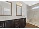 Modern bathroom features a double vanity with sleek cabinetry and a glass-enclosed shower at 320 Church St, Morrisville, NC 27560