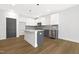 Modern kitchen with white cabinets, gray island, stainless appliances and stylish tile backsplash at 320 Church St, Morrisville, NC 27560