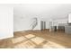 Spacious living area with hardwood floors seamlessly connected to the kitchen and staircase at 320 Church St, Morrisville, NC 27560