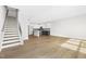 Open layout showcasing hardwood floors, a staircase, and a glimpse into the modern kitchen at 320 Church St, Morrisville, NC 27560