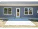 Back of home with small concrete patio and blue siding at 157 Newport Landing # 95, Garner, NC 27529