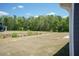 View of the open, expansive backyard and adjacent greenspace providing privacy at 157 Newport Landing # 95, Garner, NC 27529