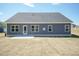 Home with gray siding and white trim with a newly seeded backyard and new concrete patio at 157 Newport Landing # 95, Garner, NC 27529