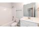Bright bathroom with white cabinets, tub, toilet, and large mirror at 157 Newport Landing # 95, Garner, NC 27529