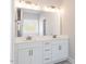 Bathroom with dual sinks, granite countertops, and a large mirror with modern lighting at 157 Newport Landing # 95, Garner, NC 27529