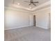 Large bedroom featuring plush carpet, tray ceiling, and natural lighting at 157 Newport Landing # 95, Garner, NC 27529
