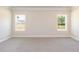 Comfortable bedroom with neutral carpet, trim and bright natural lighting from two windows at 157 Newport Landing # 95, Garner, NC 27529