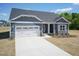 Beautiful home with a well-maintained front yard, long driveway, and attached two-car garage at 157 Newport Landing # 95, Garner, NC 27529