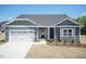 Charming home featuring a two-car garage, stone accents, and manicured front yard at 157 Newport Landing # 95, Garner, NC 27529