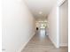 Bright hallway showcasing modern flooring, leading to an open living area with a fireplace at 157 Newport Landing # 95, Garner, NC 27529