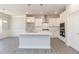 Modern kitchen featuring white cabinets, stainless steel appliances, and a large central island at 157 Newport Landing # 95, Garner, NC 27529