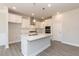 Modern kitchen featuring stainless steel appliances, a center island, and ample cabinet space at 157 Newport Landing # 95, Garner, NC 27529