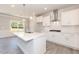 Bright kitchen with white cabinets, stainless appliances, island and adjacent dining area at 157 Newport Landing # 95, Garner, NC 27529