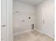 Functional laundry room with tile flooring, white walls, and shelving for storage at 157 Newport Landing # 95, Garner, NC 27529