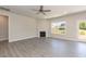 Open living room with a cozy fireplace, ceiling fan, and lots of natural light at 157 Newport Landing # 95, Garner, NC 27529