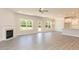 Spacious living room featuring a fireplace, large windows, and access to the kitchen at 157 Newport Landing # 95, Garner, NC 27529