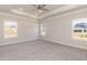 Spacious main bedroom with tray ceiling, plush carpet, and ample natural light at 157 Newport Landing # 95, Garner, NC 27529