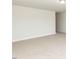 Large empty room with neutral carpet and bright recessed lighting at 157 Newport Landing # 95, Garner, NC 27529