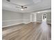 Finished basement with gray walls, white trim, vinyl floors, and a door to the outside at 1432 Quarter Pt, Raleigh, NC 27615