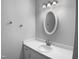 Clean bathroom with vanity, sink, decorative mirror, and neutral paint at 1432 Quarter Pt, Raleigh, NC 27615