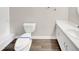 Bathroom featuring toilet with sanitary wrap, a vanity with a sink, and modern fixtures at 1432 Quarter Pt, Raleigh, NC 27615