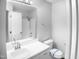 Clean bathroom with a large mirror, sink, and shower with white walls at 1432 Quarter Pt, Raleigh, NC 27615