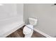 Bright bathroom featuring white toilet with sanitary wrap, tub, shower, and fixtures at 1432 Quarter Pt, Raleigh, NC 27615