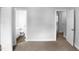 This bright bedroom features an open doorway to a bathroom and an open doorway to a hallway at 1432 Quarter Pt, Raleigh, NC 27615