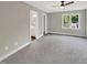 Bright and spacious bedroom with neutral walls, carpet, and a view to the backyard at 1432 Quarter Pt, Raleigh, NC 27615