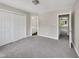 Bedroom with gray carpet, closet, and doorways to the bathroom and the hallway at 1432 Quarter Pt, Raleigh, NC 27615