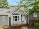 Charming home featuring manicured landscaping, neutral colors, and a quaint entryway at 1432 Quarter Pt, Raleigh, NC 27615