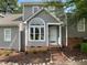 Charming home featuring a unique arched window and well-maintained landscaping at 1432 Quarter Pt, Raleigh, NC 27615