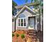 Charming home featuring a peaked roof, brick foundation, an arched window, and landscaped front yard at 1432 Quarter Pt, Raleigh, NC 27615