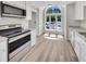Bright eat-in kitchen featuring stainless appliances, granite countertops and large arched windows offering great views at 1432 Quarter Pt, Raleigh, NC 27615