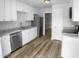 Modern kitchen with stainless steel appliances, granite countertops, and hardwood floors at 1432 Quarter Pt, Raleigh, NC 27615