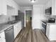 Modern kitchen features stainless steel appliances, hardwood floors, and bright lighting at 1432 Quarter Pt, Raleigh, NC 27615