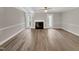Spacious living room with fireplace, neutral walls, wood-look floors, and doors to the backyard at 1432 Quarter Pt, Raleigh, NC 27615